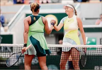  ?? Ryan Pierse / Getty Images ?? Amanda Anisimova, right, of the U.S., seeded 27th, celebrates her victory against Naomi Osaka during the first round of the French Open at Roland Garros on Monday.