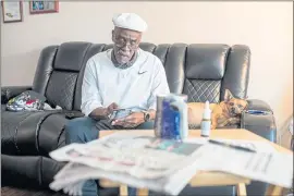  ?? PHOTOS BY RAY CHAVEZ — STAFF PHOTOGRAPH­ER ?? Malcolm Jones, 72, tries his luck with scratch lottery tickets at his home in Richmond. A counselor at a Berkeley homeless center, Jones has no retirement savings.