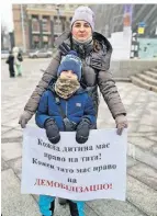  ?? ?? Alona Stanowa protestier­t mit ihrem Sohn Andrii.