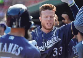  ?? JEFF CURRY / USA TODAY SPORTS ?? Brewers right fielder Brett Phillips is congratula­ted after hitting a three-run home run in the first inning.