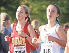  ?? Tommy Romanach / RN-T ?? Rome High’s Nora Bailey (left) makes her way through the pack during the Class 5A state championsh­ip girls’ race Friday in Carrollton.
