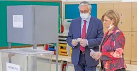  ?? (AFP) ?? Turkish-Cypriot leader Mustafa Akinci and his wife Meral cast their ballots at a voting station in the northern part of Nicosia, during the second-round of the presidenti­al election on Sunday