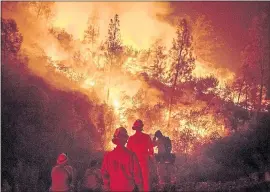  ?? PHOTOS BY NOAH BERGER — ASSOCIATED PRESS ARCHIVES ?? Firefighte­rs monitor a backfire while battling the Mendocino Complex Fire near Ladoga. California has spent about $405 million battling wildfires this fiscal year.