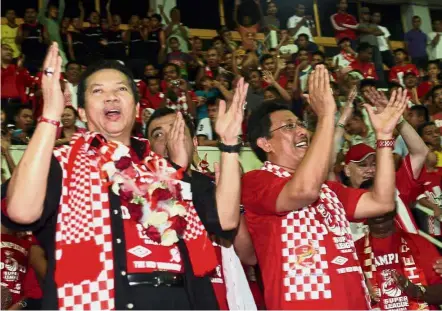  ??  ?? In the spotlight: Annuar (left) celebratin­g after Kelantan won the Super League title in 2011.