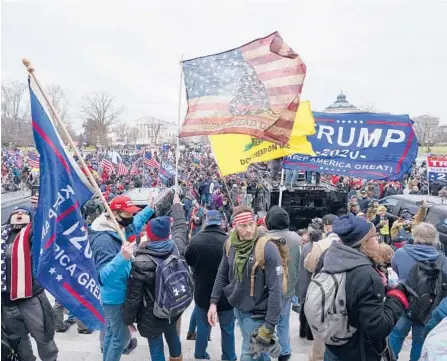  ?? ?? Insurrecti­onists loyal to then-President Donald Trump swarm the Capitol on Jan. 6 in Washington. Robert Palmer was sentenced to more than five years in prison. MANUEL BALCE CENETA/AP