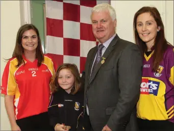  ??  ?? G.A.A. President Aogán Ó Fearghaíl is welcomed to Murrintown N.S. by Aideen Brazil (teacher), Sheila Rowe (pupil) and Maureen Gilbane (principal) on his recent visit to promote Féile na nGael.