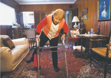  ?? Paul Chinn / The Chronicle ?? Every afternoon, Norma Ratto — who turns 100 on Oct. 24 — does 20 leg lifts using her walker for balance.