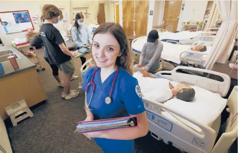  ?? KAZANJIAN/AP GARY ?? Emma Champlin, a first-year nursing student in California, said the pandemic has given her a chance to learn and apply critical-care skills.