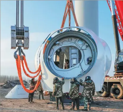  ?? WANG ZHENG / FOR CHINA DAILY ?? Wind turbines are installed at Hinggan League, Inner Mongolia autonomous region, in December.