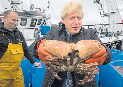  ?? Picture: PA. ?? Feeling the pinch: Boris Johnson on the Carvela with Karl Adamson at Stromness on a visit to Scotland last month, amid polls showing considerab­le support for independen­ce.