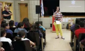  ?? MARTHA IRVINE — THE ASSOCIATED PRESS ?? Dawn Iles-Gomez, principal at Nathan Hale Elementary School, speaks to some of her students in Chicago on Friday. She often speaks about her dislike of social media and the impact it has on her students’ lives. “It’s shocking — the language and the threats and the mean things that are said (on social media),” she says. And she says often parents have no clue or would rather not deal with it.