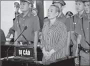  ?? AP/BICH HUE ?? Activist Le Dinh Luong (center) stands for sentencing Thursday in the central province of Nghe An, Vietnam.