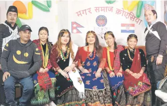  ?? Photos — AFP ?? Dhami Man Singh (second left), 43, owner of “Himalaya Curry Nepali”, and foreign workers from Nepal, dressed in local folk costumes, pose for a photo in Nepalese restaurant “Himalaya Curry Nepali”, in the centre of Zagreb, Croatia.