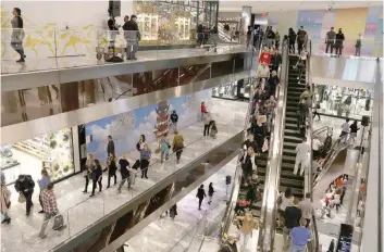  ?? — Reuters ?? People tour the shops during the grand opening of The Hudson Yards developmen­t, a residentia­l, commercial and retail space on Manhattan’s West side in New York City, New York, US.