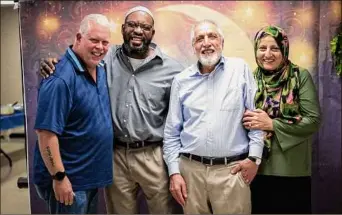  ?? Muncie Fine Portraits /Munciefine­portraits.com ?? From left to right: Richard "Mac" Mckinney, Jomo Williams, Dr. Saber Bahrami and Bibi Bahrami at the Muncie Islamic Center in Muncie, Ind.