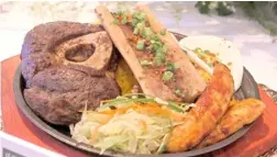  ?? ?? SIZZLING Lè Chon Bulalo Steak served with butter rice, flavored corn ribs, banana cue chips, bone marrow and egg.