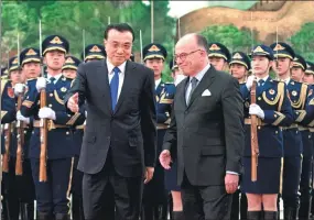  ?? FENG YONGBIN / CHINA DAILY ?? Premier Li Keqiang welcomes French Prime Minister Bernard Cazeneuve at the Great Hall of the People in Beijing on Tuesday.