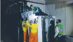  ?? (ZAKA) ?? ZAKA MEMBERS HELP to install a backup generator in northern Miami on Monday in the aftermath of Hurricane Irma.