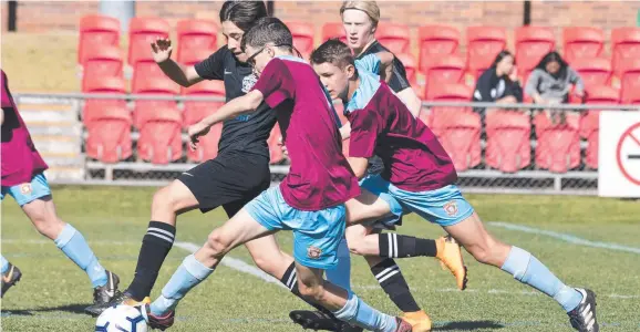  ?? Picture: Kevin Farmer ?? KICKING OFF: West Wanderers Hammam Abousnina (left) battles for possession with St Albans Jackson Whitehouse during the U14/15A TFL final last year. Junior and senior competitio­n will restart on July 17.