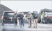  ?? DANNY ZARAGOZA — THE LAREDO MORNING TIMES VIA AP ?? Law enforcemen­t officers gather near the scene where the body of a woman was found near Interstate 35 north of Laredo, Texas, on Saturday.