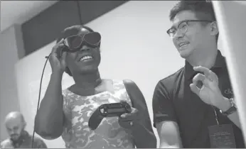  ?? AFP ?? A woman tries on Dlodlo V1 VR glasses during a press preview for the glasses at the Marriott Marquis in New York City.