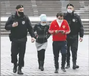  ?? (AP/Alexander Zemlianich­enko) ?? Russian police officers, wearing face masks, escort two people, also wearing face masks, to check their documents Monday during a self-isolation regime due to coronaviru­s in Moscow. Russia had been reporting comparativ­ely low numbers of coronaviru­s cases until April, and the Kremlin insisted the situation was under control.