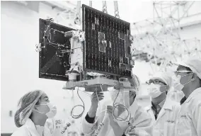  ??  ?? Top: A Long March-2D carrier rocket, carrying a space environmen­t research satellite and four nanosatell­ites, blasts off from theJiuquan Satellite Launch Center at 7:40am yesterday. — Xinhua Above: Technician­s from Space OK check the Jiading-1 nanosatell­ite at the Jiuquan center before yesterday’s launch. — Ti Gong