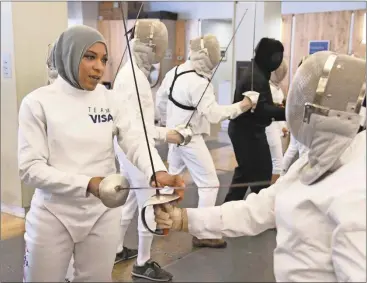  ?? Charles Sykes/AP ?? In this June 2, 2016, file photo, Team Visa athlete Ibtihaj Muhammad leads an interactiv­e fencing demonstrat­ion in New York. This year more than ever, the so-called ``face’’ of the Olympics could be a wrestler, or a fencer, or an athlete who most of...