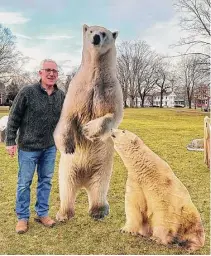  ?? Lauren Dillion Knight ?? Guilford First Selectman Matt Hoey welcomes polar bears to the green Monday. The art installati­on of 44 wooden polar bears was the work of an anonymous artist.