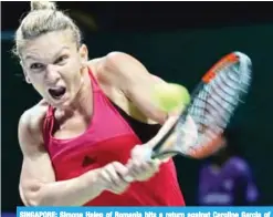  ??  ?? SINGAPORE: Simona Halep of Romania hits a return against Caroline Garcia of France during the WTA Finals tennis tournament in Singapore yesterday. — AFP