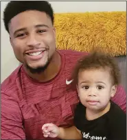  ?? (Submitted photo) ?? Former University of Arkansas tight end Koilan Jackson poses for a photo with his son Kairo. Jackson became the first student-athlete to sign a name, image and likeness agreement to support fathers through the Legacy Letter Challenge.