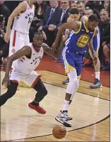  ??  ?? Durant injures himself while driving against Toronto’s Serge Ibaka and limps away during Game 5 of the NBA Finals at Scotiabank Arena in Toronto on Monday.