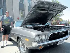  ?? RAY SPITERI/POSTMEDIA NEWS ?? Bill Knox, of Fort Erie, shows his 1973 Dodge Challenger at the Cruising on the Q event in downtown Niagara Falls on Sunday. The event welcomed the Canadian Coasters, a national club that is doing coast-to-coast trip to celebrate its 50th anniversar­y.