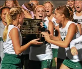  ?? SAM STEWART - DIGITAL FIRST MEDIA FILE ?? Methacton’s Emily Owens holds up the Pioneer Athletic Conference plaque while surrounded by her teammates following the Warriors’ 3-1 victory over Owen J. Roberts in the PAC title game.