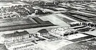  ??  ?? Der Flughafen hat klein angefangen: Die Gebäude befanden sich damals im westlichen Bereich des Geländes. Im Bildhinter­grund sieht man den heutigen Stadtteil Lohausen.