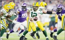  ??  ?? In this Dec 23, 2019 file photo, Green Bay Packers quarterbac­k Aaron Rodgers (12) hands the ball off during the second half of the team’s NFL
football game against the Minnesota Vikings in Minneapoli­s. (AP)