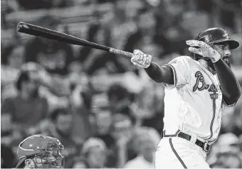  ??  ?? Atlanta’s Nick Markakis drives in a run with a third-inning hit during Friday’s game against Philadelph­ia. He was 3-for-3 with two doubles and an RBI as the Braves beat the Phillies 2-1.