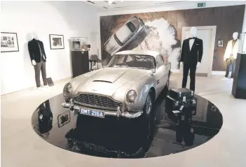  ?? — AFP photo ?? An Aston Martin DB5 stunt car from the film ‘No Time to Die’ is displayed during a photocall ahead of the ‘Sixty Years of James Bond’ auction at Christie’s auction house in London.