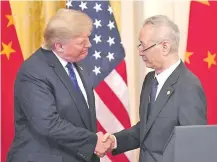  ??  ?? El presidente de EE.UU., Donald Trump, y el vice primer ministro chino, Liu He, durante la firma del acuerdo (AFP).