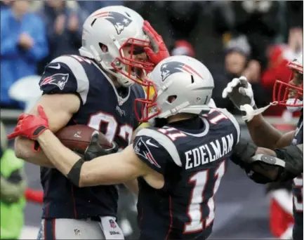  ?? CHARLES KRUPA — THE ASSOCIATED PRESS ?? Patriots tight end Matt Lengel, left, celebrates his touchdown catch with Julian Edelman, center, and Malcolm Mitchell in the first half.