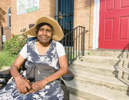  ?? REBECCA SANTANA/AP ?? Sonia St. Cyr, a New Orleans resident, sits outside the Broadmoor Community Church on July 21. The church is part of a program installing solar panels and batteries to serve communitie­s in case of extended power outages.