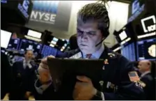  ?? ASSOCIATED PRESS FILE ?? Trader John Panin works on the floor of the New York Stock Exchange.