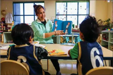  ?? PHOTOS: RAY CHAVEZ — STAFF PHOTOGRAPH­ER ?? Teacher Gemma Monreal reads to Matias Lopez, left, and Camilo Guillen, both 4, during a Head Start program at the George Miller III Center in Richmond on Friday. The location, which serves 124student­s, will soon mark its 20th anniversar­y.