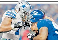  ??  ?? STUCK ON YOU: Cullen Jenkins (right) gets his helmet stuck to Tyron Smith’s during the Giants’ 27-26 loss on Sunday.