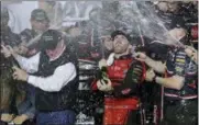  ?? TERRY RENNA — THE ASSOCIATED PRESS ?? Austin Dillon celebrates with his team and his grandfathe­r, Richard Childress, left, in Victory Lane after winning the NASCAR Daytona 500 Cup series auto race at Daytona Internatio­nal Speedway Sunday. With Dillon’s victory in the famed No. 3 and Bubba...