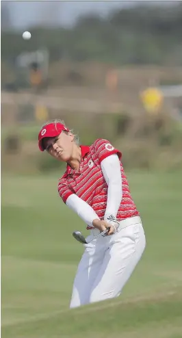  ?? ALASTAIR GRANT/ THE ASSOCIATED PRESS ?? Brooke Henderson, seen hitting onto the green during the final round at the Summer Olympics in Rio on Saturday, is back on home soil getting set for the Canadian Open starting Thursday in Priddis, Alta.