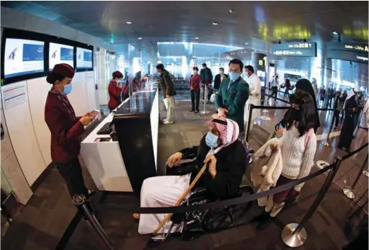  ??  ?? Passengers heading to the departure lounge to take the Riyadh flight at Hamad Internatio­nal Airport near Doha on January 11, 2021, as flights resumed between Qatar and Saudi Arabia