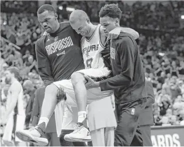  ?? Karen Warren / Houston Chronicle ?? Spurs point guard Tony Parker had to be carried off the court in the fourth quarter Wednesday when he landed awkwardly and appeared to injure his left knee during San Antonio’s 121-96 win over the Rockets.