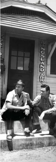  ?? (Special to The Commercial) ?? In 1959, during one of his many visits back to Kingsland, Johnny Cash (right) points out the Cotton Belt Railroad depot to his friend and fellow recording artist Johnny Horton while sitting on the old Post Office steps.