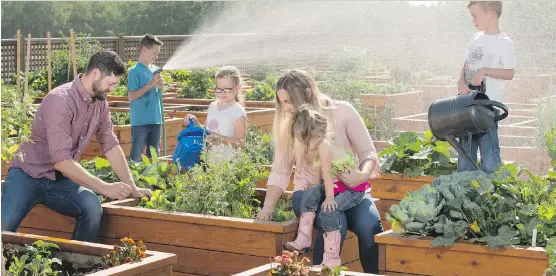  ?? DON MOLYNEAUX ?? Josh and Katie Capps with their children Kail, 9, Ava, 7, Zach, 5, and Cora, 3, in the community garden in Legacy. The family is having fun and also eating more vegetables.